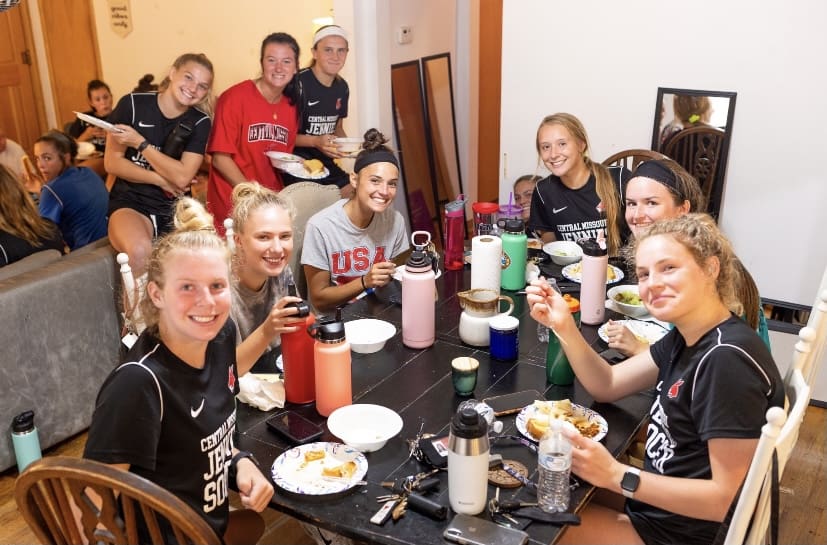 Young athletes having nutritious food together