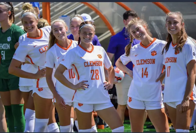 A Group of Girls in White Jersey and Orange Wording